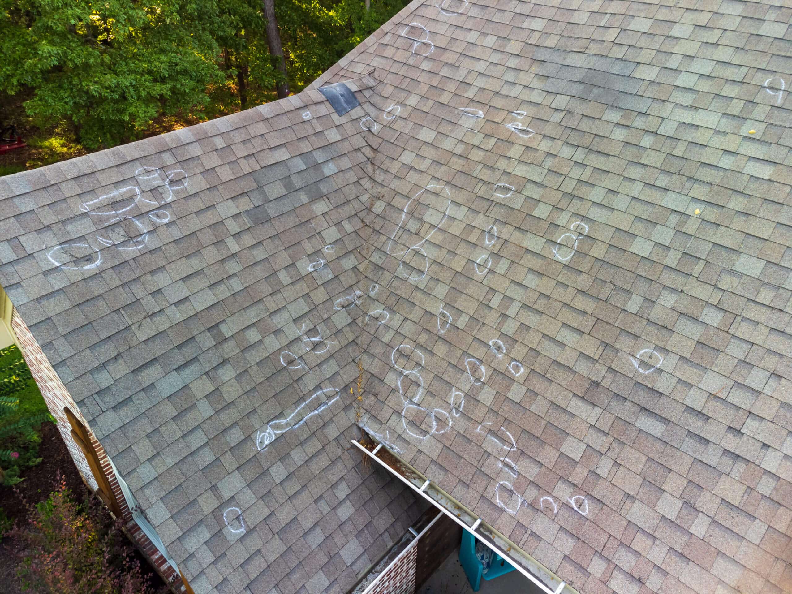 Roof with hail damage and markings from free roof inspection